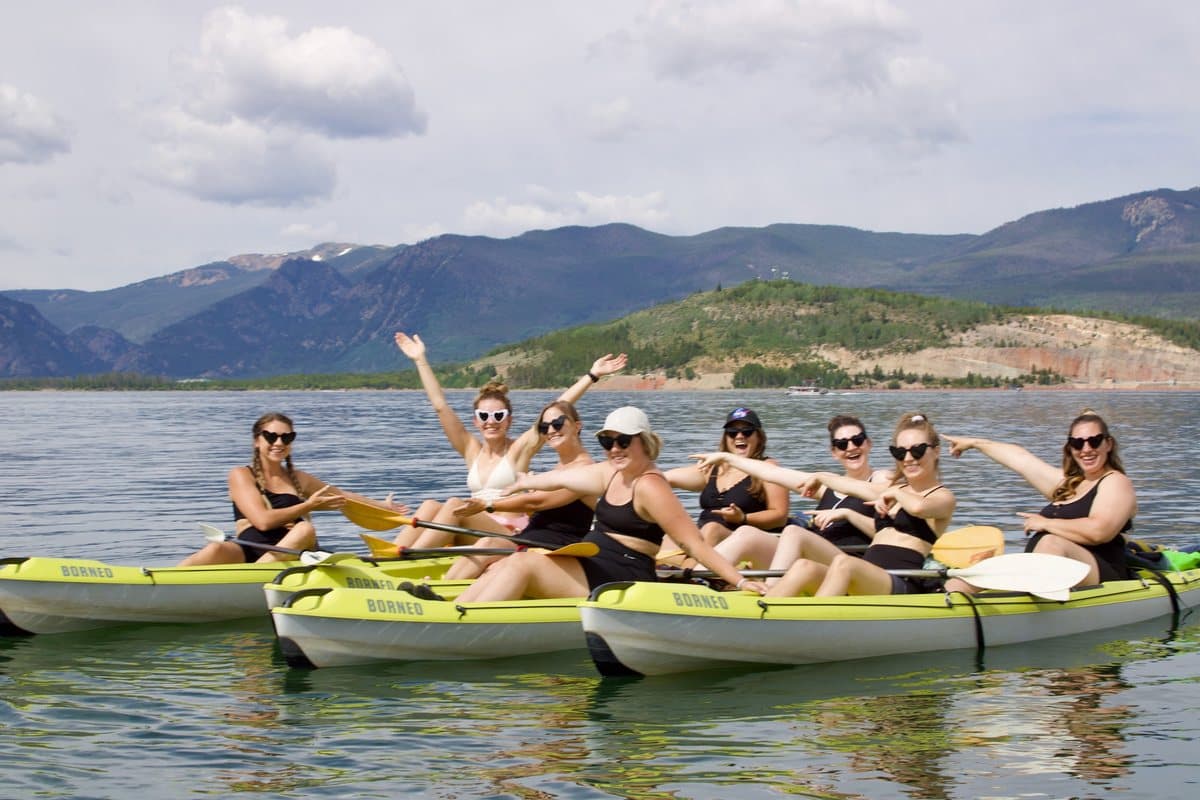 A group of friends paddling together in a kayak on Lake Dillon